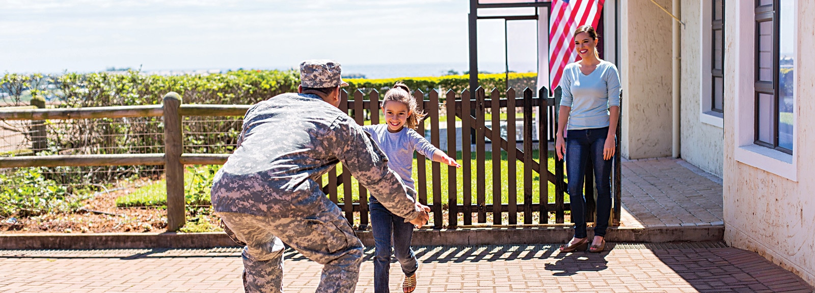 Child running toward military father in celebration