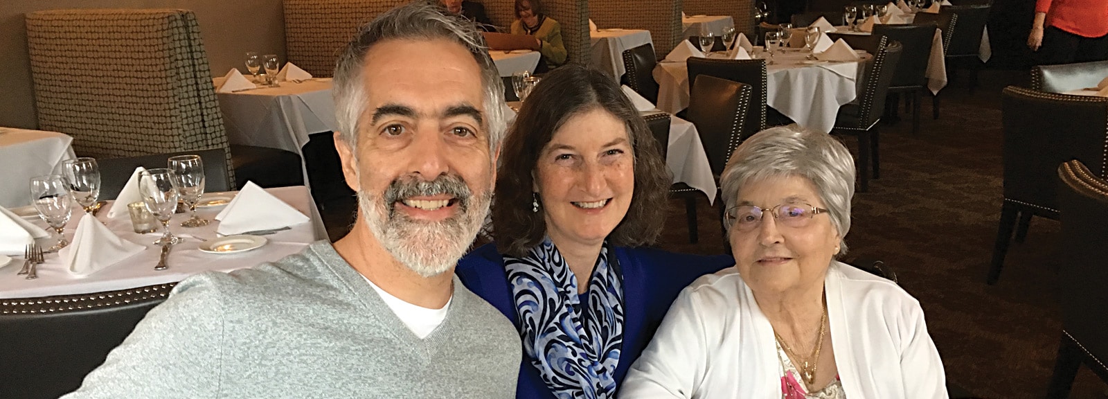 Dr. Richard Rayner with his wife and mother at a restaurant table